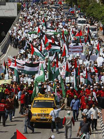 BANTAHAN... Sebahagian aktivis dan anggota pertubuhan bukan kerajaan (NGO) Islam membawa sepanduk dan kain rentang bagi membantah serangan Israel ke atas bumi Islam Palestin ketika menghantar memorandum bantahan ke Kedutaan AS di Jalan Tun Abdul Razak hari ini. -FotoAP