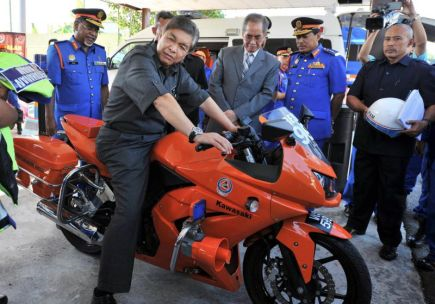 Menteri Dalam Negeri, Datuk Seri Ahmad Zahid Hamidi mencuba sebuah motosikal yang digunakan anggota Jabatan Pertahanan Awam Malaysia (JPAM) semasa kerja-kerja menyelamat ketika melakukan lawatan ke Ibu Pejabat JPAM di Kuala Lumpur pada Selasa. Turut kelihatan Timbalan Menteri Dalam Negeri, Datuk Seri Dr Wan Junaidi Tuanku Jaafar (tiga, kanan). -fotoBERNAMA 