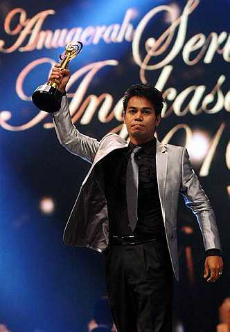 Fauzi Nawawi menjulang trofi Anugerah Pelakon Lelaki Drama TV Terbaik yang dimenanginya di Anugerah Seri Angkasa 2010 di Pusat Dagangan Dunia Putra (PWTC), Kuala Lumpur, Sabtu. - Foto SHAARI CHE MAT